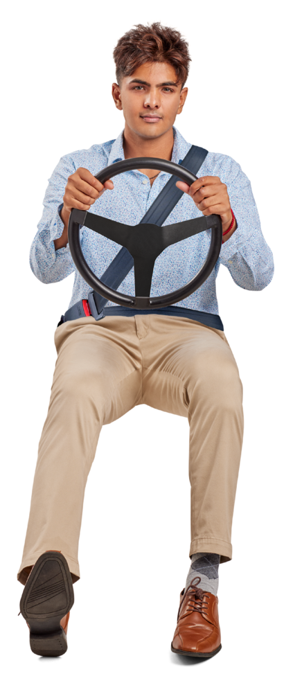 Young man seated holding a steering wheel while dressed to go out