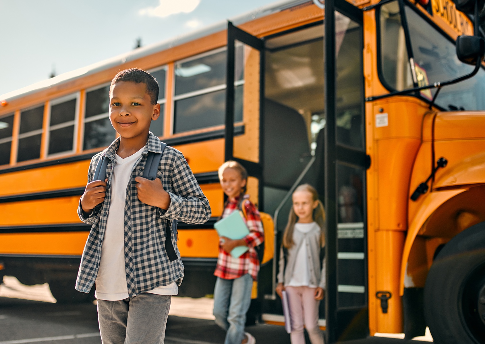 Kids leaving a school bus.