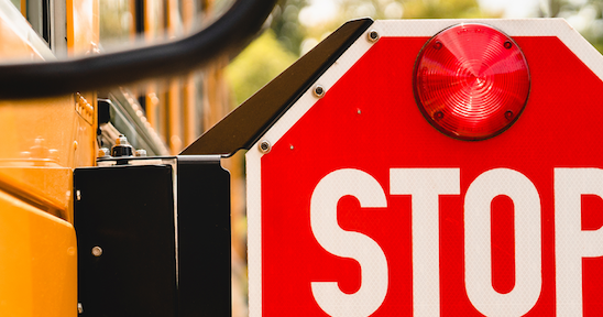 Stop arm of a school bus in the open position. 
